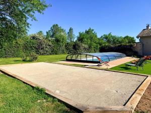 a park with a bench and a glass bridge at Villa nest in Saint-Sauvant