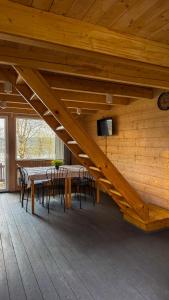 a staircase in a room with a table and chairs at Osada Kryspinów in Cholerzyn