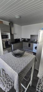 a kitchen with a table with a bowl on it at La casa valentine in Calais