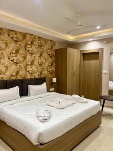 a bedroom with a large bed with towels on it at Hotel Airport View in Pāsighāt