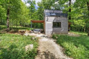 a tiny house in the woods with a patio at Cabane Spa - Noyers - Proche Sarlat in Jayac