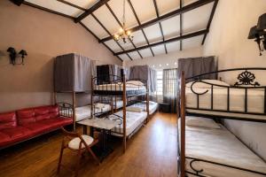 a room with four bunk beds and a couch at Great Shanghai Guesthouse in George Town