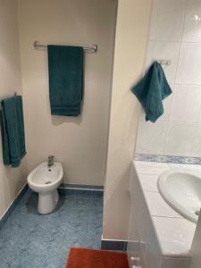 a bathroom with a toilet and a sink and green towels at Dolce Vita à Nice in Nice +12 photos