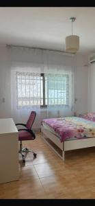 a bedroom with a bed and a desk and a chair at Jordan Amman in Amman