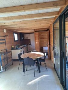 a kitchen and dining room with a table and chairs at Chalet des Briseux in Saint-Maurice-sur-Moselle