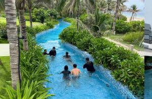 a group of people in the water on a lazy river at Hà Lịch Light B0719 in Cam Ranh International Airport