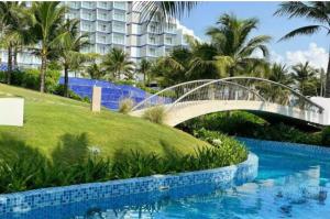 a bridge over a pool in front of a building at Hà Lịch Light B0719 in Cam Ranh International Airport