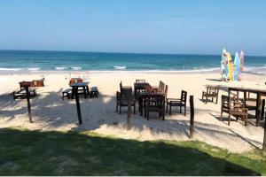 a group of tables and chairs on the beach at Hà Lịch Light B0719 in Cam Ranh International Airport