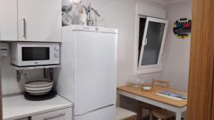 a kitchen with a white refrigerator and a microwave at Apartamento Markina Xemein in Marquina-Jemein