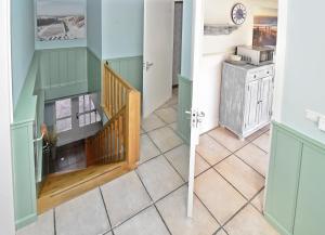 a hallway with a staircase in a house at Bed en Bad De Koog in De Koog