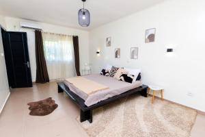 a bedroom with a bed in a white room at Duplex MNE in Douala