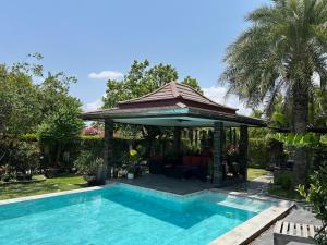 a gazebo and a swimming pool in a yard at Siri Thai Lodges in Hua Hin
