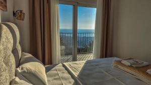 a bedroom with a bed and a large window at Olive Grove Luxury with private POOL in Bar