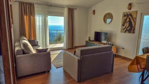 a living room with two chairs and a television at Olive Grove Luxury with private POOL in Bar +35 photos
