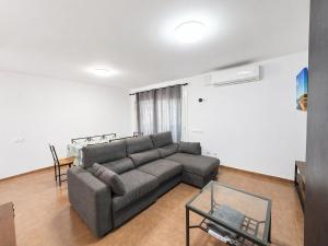 a living room with a couch and a glass table at Apartamento Luna en Conil in Conil de la Frontera +21 photos
