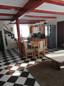 a kitchen and dining room with a table and chairs at Cabana Gabriel Bucovina in Vatra Dornei