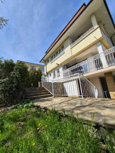 a building with stairs and a balcony on it at Blue Summer in Obzor