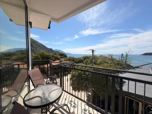 a balcony with chairs and a view of the water at Beachfront Hotel Palma - Jaz in Budva