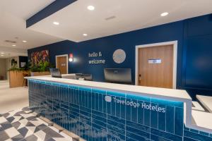 a swimming pool in a hospital lobby with a blue wall at Travelodge Bilbao Sestao in Sestao