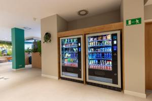 two soda machines in a store with drinks at Travelodge Bilbao Sestao in Sestao