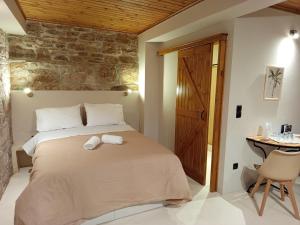 a bedroom with a large bed and a table at cozystudio Chezmoi in Chios