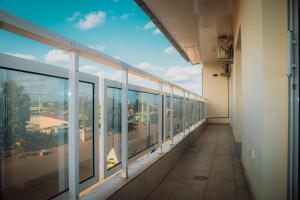 an empty hallway of a building with a view of a city at L'appartement Bleu d'Assinie in Assinie