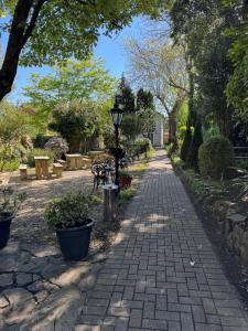 a brick walkway with a street light and trees at Castle View Hotel in Chepstow +4 photos