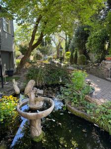 a bird bath in a pond in a garden at Castle View Hotel in Chepstow