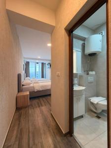 a room with a bedroom with a bed and a sink at Beachfront Hotel Palma - Jaz in Budva +271 photos