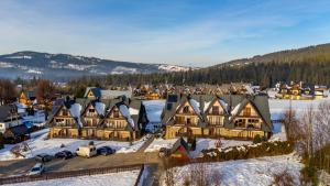 an aerial view of a large house in the snow at WHY NOT Apartament Krywań in Kościelisko +5 photos