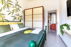 a bedroom with a bed with a large headboard at Aromatico design 2 camere da letto / centralissimo in Diano Marina