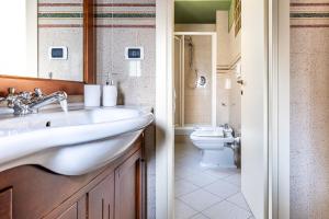 a bathroom with a sink and a toilet at Aromatico design 2 camere da letto / centralissimo in Diano Marina +19 photos
