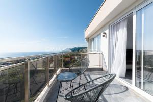 a balcony with chairs and a view of the ocean at Elegant Seaview 1bd in Dobre Vode in Dobra Voda