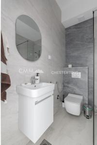 a bathroom with a white sink and a mirror at Elegant Seaview 1bd in Dobre Vode in Dobra Voda +5 photos