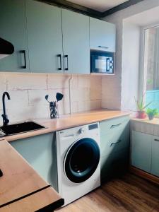 a kitchen with a washing machine on a counter at Лофт в самом сердце Караганды in Karagandy +17 photos