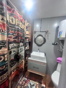 a bathroom with a sink and a toilet at Лофт в самом сердце Караганды in Karagandy