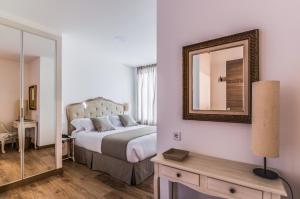 Posteľ alebo postele v izbe v ubytovaní Suite Home Sardinero