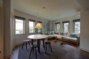 a living room with a table and a couch at The Apartment Hotel Shibuya 3 in Tokyo