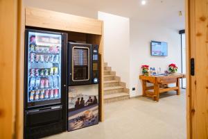 a refrigerator filled with drinks in a room at Residence Diamant in Andalo