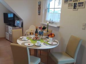 a dining room table with food and fruit on it at Ferienwohnung 15 in Koserow in Koserow +9 photos