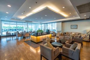 a lobby with a waiting room with couches and tables at Kantary Hotel Kabinburi in Kabin Buri