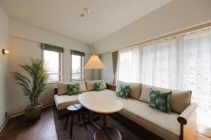 a living room with a couch and a table at The Apartment Hotel Shibuya 3 in Tokyo