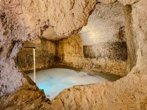 a bath tub in a cave with water in it at XUQ Hotels Lomas de Ruvira in Jorquera +208 photos