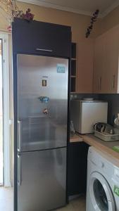 a refrigerator in a kitchen with a washing machine at Koufos House in Sparta