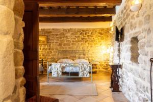 a room with a table in a stone wall at Agriturismo La Palazzetta di Assisi in Assisi +37 photos