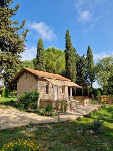 an old house in a garden with a fence at Château de Bayssan in Béziers