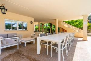 a dining room with a white table and chairs at Villa Arenas in El Arenal