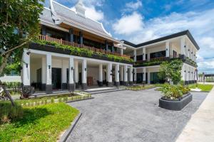 an exterior view of a building with a courtyard at Ozone Condominium BangTao Laguna Area in Phuket