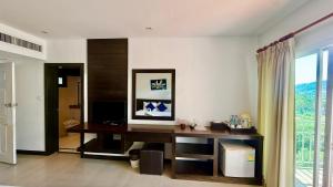 a living room with a desk and a window at APK Resort in Patong Beach