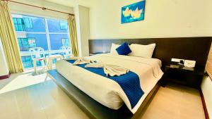 a large bed in a room with a large window at APK Resort in Patong Beach +90 photos